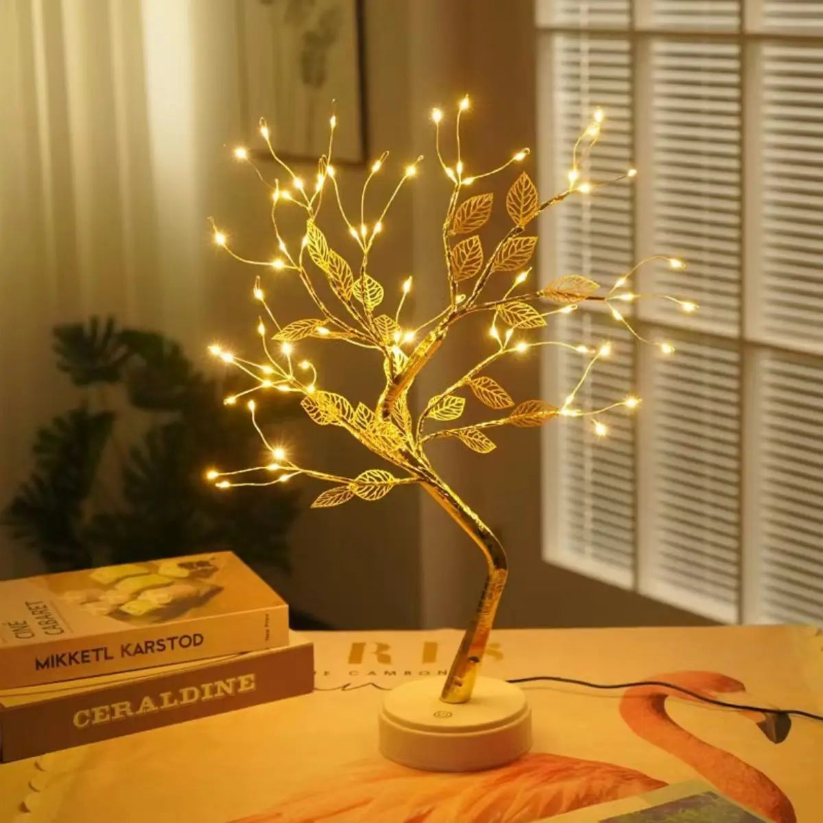 LED golden leaf tree lamp glowing warm white on a bedroom shelf