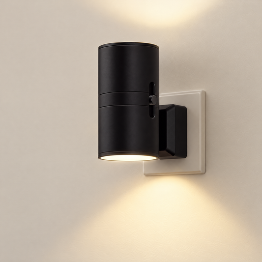 Black plug-in mood light glowing on a wall